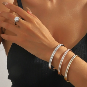 Titanium steel bangle set and diamond-encrusted ring in silver, gold, and rose gold finishes