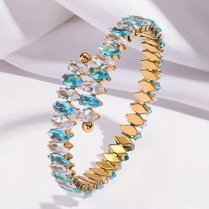 Gold-plated wrap bracelet with marquise-cut blue and clear zircon stones on silk fabric