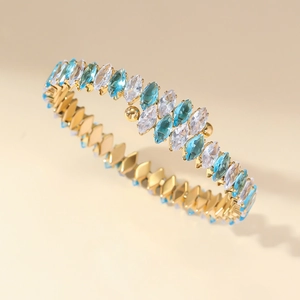 Golden stainless steel cuff bracelet with sparkling marquise-cut blue and clear zircon