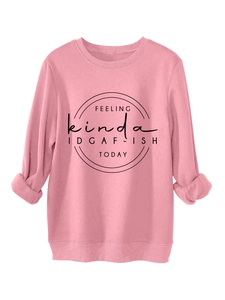 Close-up of pink crewneck sweatshirt featuring IDGAF-ISH slogan print and soft texture