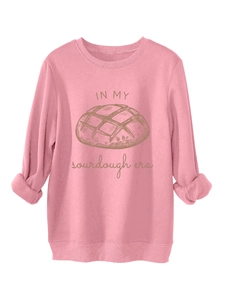 Détail du sweat rose à col rond avec texte In My Sourdough Era et illustration de pain