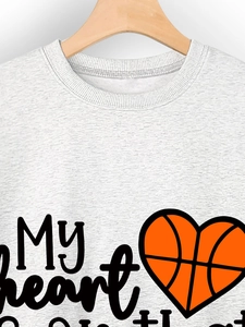 Detail of My Heart slogan and orange basketball heart print on heather grey sweatshirt