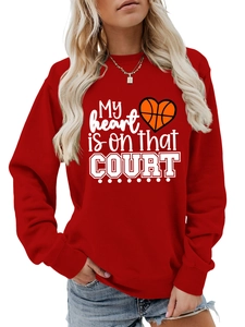 Detail of red crewneck sweatshirt featuring basketball heart print and letter graphics