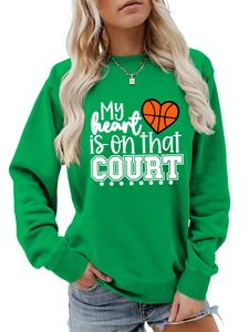 Detail of green crewneck sweatshirt featuring orange heart basketball slogan print