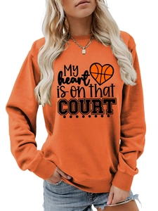 Detail of orange sweatshirt featuring My heart is on that COURT basketball print