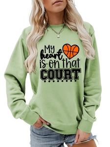 Detail of light green sweatshirt featuring heart basketball graphic and ribbed knit cuffs