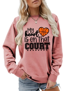 Detail of light pink sweatshirt featuring My heart is on that COURT basketball print