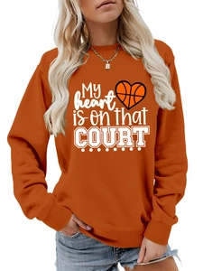 Detail of bright orange sweatshirt with My heart is on that COURT basketball print
