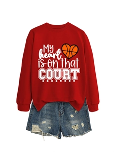 Detail of red crewneck sweatshirt with heart basketball print and ripped denim shorts