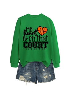 Green long-sleeve sweatshirt with basketball heart print paired with denim shorts