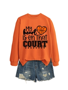 Detail of orange sweatshirt with My heart is on that court print and denim shorts