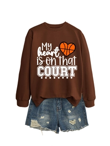 Flat lay of brown 'My heart is on that COURT' sweatshirt with distressed denim shorts