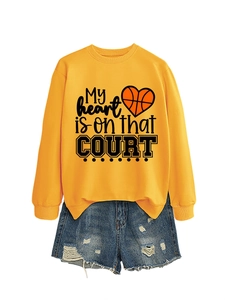 Detail of orange sweatshirt with My Heart is on That Court basketball print and denim shorts