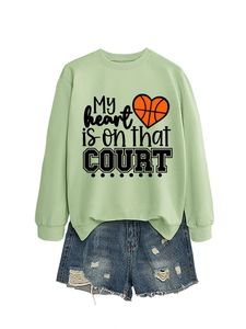 Flat lay of a green basketball sweatshirt with denim shorts and My Heart printed text