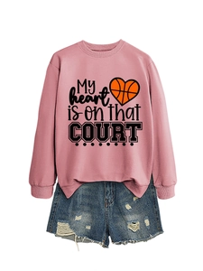 Detail of pink sweatshirt with My heart is on that court print and ripped denim shorts