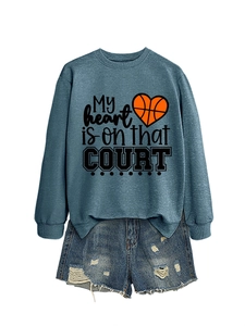 Detail of loose fit sweatshirt with heart basketball print and ripped denim shorts