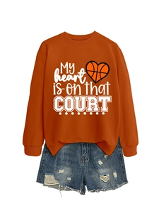 Detail of orange sweatshirt with My heart is on that court print and distressed denim shorts
