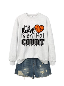 Flat lay detail of grey sweatshirt and distressed denim shorts with basketball print