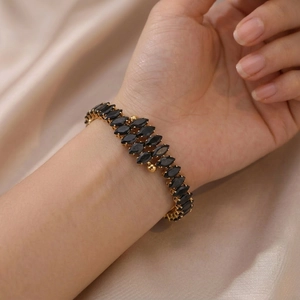 Golden titanium steel bangle with double rows of marquise-cut black zircon on champagne silk