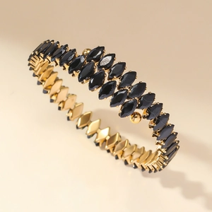 Golden open bangle with layered marquise-cut black zircons in a luxurious layered design