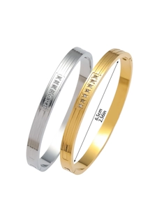 Detail of 18K gold and silver titanium bangles showing 6.5cm diameter and zircon inlay