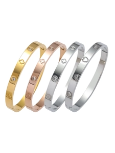 Vue détaillée des bracelets en acier inoxydable gravés de trèfles, cœurs et cristaux