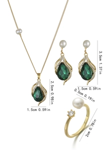 Detailed set of gold jewelry with green water drop stones and white pearls