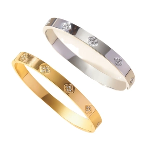 Titanium steel bangles with clover patterns in gold and silver colors featuring crystals