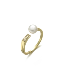Detailed macro view of an open gold ring featuring a white pearl and zircon accents
