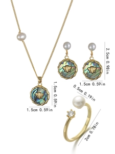 Detailed view of bee jewelry set with abalone shell and freshwater pearls on white background