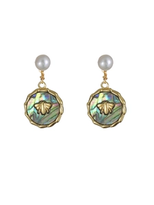 Detailed macro view of honeybee earrings featuring abalone shell and white pearls
