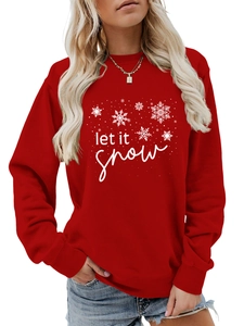 Close-up of Let It Snow text and white snowflake print on a red long sleeve sweatshirt
