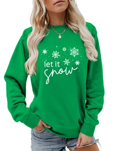 Close-up of let it snow text and white snowflake print on green crewneck sweatshirt