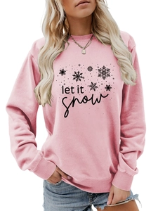Detail of pink crewneck sweatshirt with black let it snow text and snowflake pattern