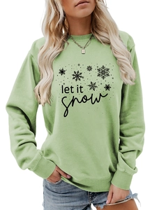Close-up of Let It Snow text and snowflake print on light green sweatshirt fabric