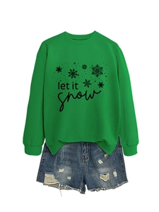 Flat lay of green Let It Snow sweatshirt with snowflake print and denim shorts