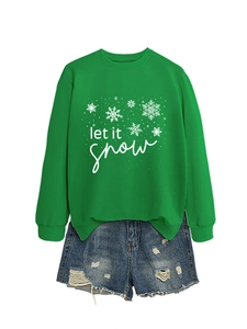 Detail of Let It Snow green sweatshirt paired with distressed denim shorts