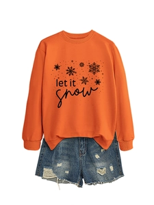 Detail of Let It Snow orange sweatshirt with snowflake print and distressed denim shorts