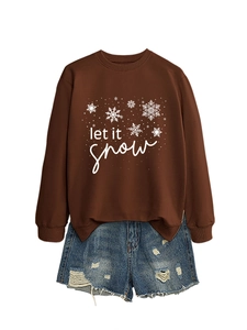 Flat lay of brown Let It Snow sweatshirt paired with distressed denim shorts