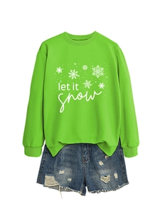 Close-up of let it snow white graphic print and snowflake details on green sweatshirt