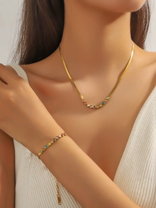 Detailed view of a gold snake chain set with colorful round-cut zircon gemstone pendants