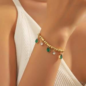 Elegant gold titanium steel bracelet with emerald waterdrop pendants and white zircons
