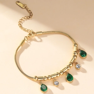 Gold plated stainless steel bracelet with emerald teardrop charms and round zircons