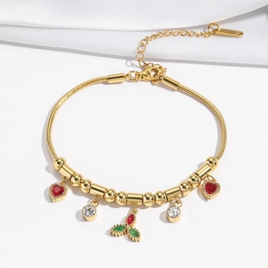 Gold snake chain bracelet with red heart charms and zircon flower pendant on silk background