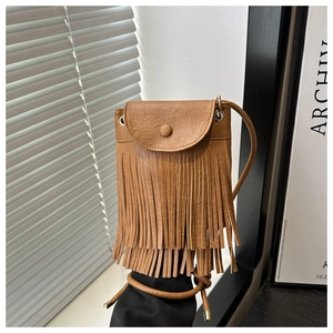 Detailed view of brown fringe cell phone bag with vintage faux leather texture and tassel