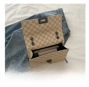 Detail view of the retro flap bag interior showing capacity for phone and wallet