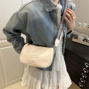 Fashionable cream white pillow bag with a stylish geometric woven wide strap for women