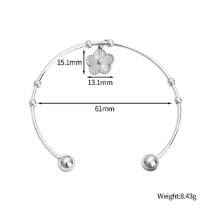Bracelet jonc poli en acier inoxydable avec pendentif floral et boules argentées