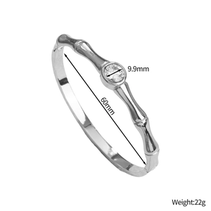 Detail of silver bamboo style bangle with a 9.9mm round sparkling crystal centerpiece