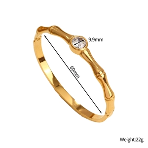 Detail view of golden bamboo style bracelet showing 9.9mm stone and 60mm diameter dimensions